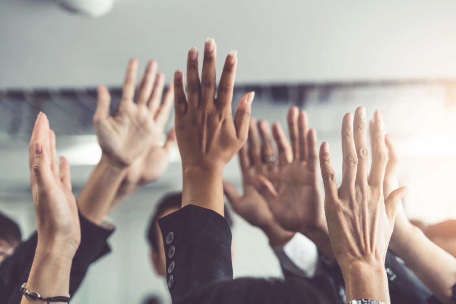 Team members collaborating on curriculum development with notebooks and reference materials